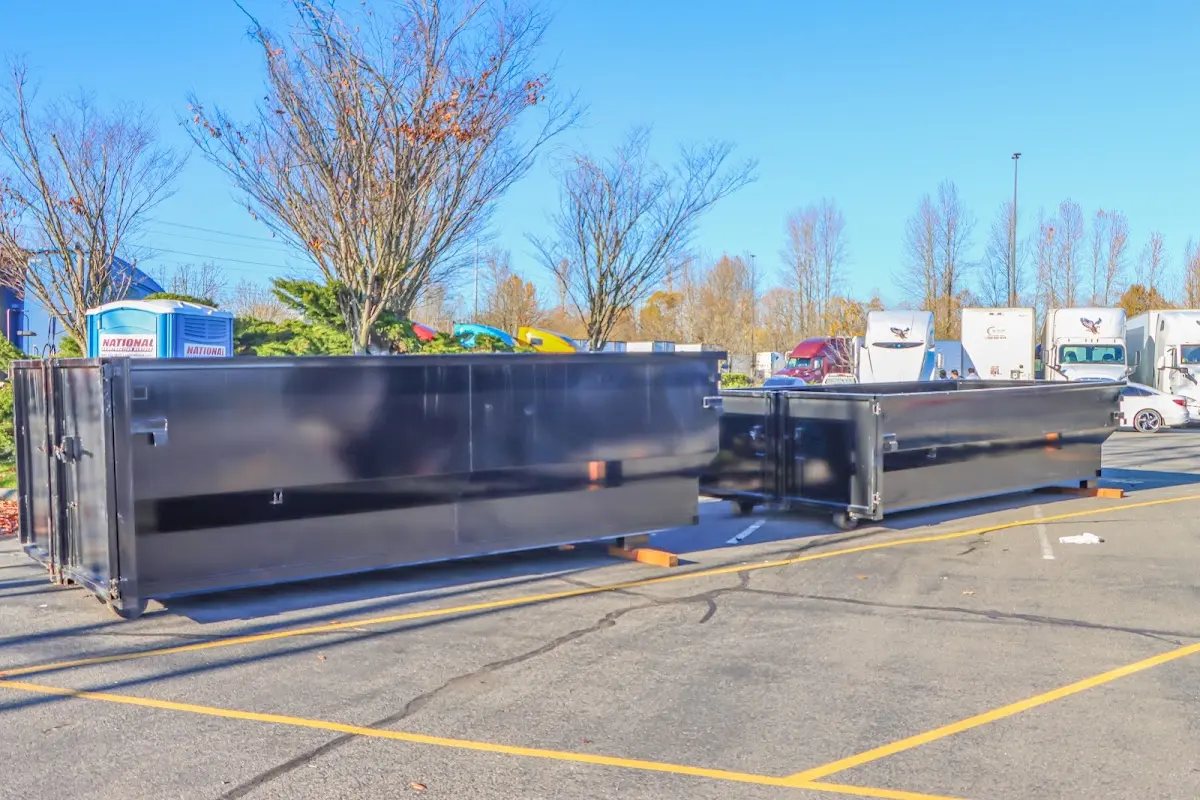 Professional dumpster rental service with roll-off container on residential driveway in Polk